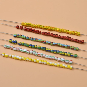 Macro detail of striped candy-colored glass beads in assorted patterns for DIY jewelry craft