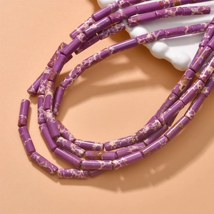 Close-up of purple cylindrical stone beads with natural texture for DIY jewelry making