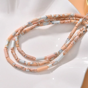 Macro detail of pink and white marble texture cylindrical tube beads for DIY jewelry
