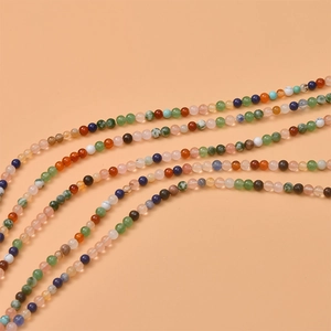 Close-up of mixed natural stone beads in curved rows for DIY jewelry making