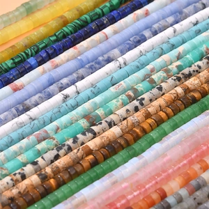Detailed view of colorful cylindrical stone beads in various textures for DIY jewelry
