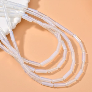 Macro detail of translucent white cylindrical crystal beads with a pearlescent finish