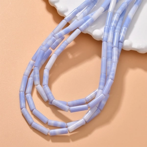 Macro detail of natural blue and white striped cylindrical agate beads for jewelry DIY