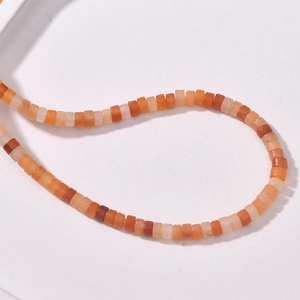 Macro view of assorted warm-toned natural stone tube beads for DIY jewelry making