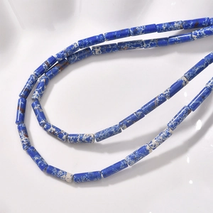 Macro shot of blue cylindrical stone beads with natural white and brown texture patterns