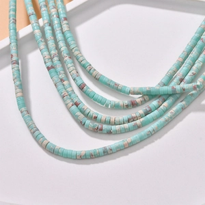 Macro detail of turquoise disc beads with natural marble texture for DIY jewelry making