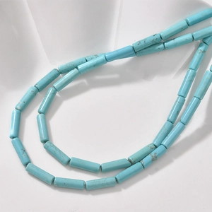 Macro shot of turquoise blue cylindrical tube beads with natural vein textures for jewelry