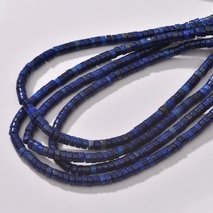 Macro shot of square cut natural lapis lazuli beads with blue mineral texture
