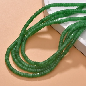 Macro detail of green natural stone cylinder beads for DIY jewelry making and necklaces