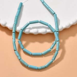 Macro shot of turquoise blue cylindrical stone beads with brown veins for DIY jewelry