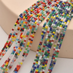 Macro view of colorful 2mm cube glass beads in multi-color strands for DIY jewelry making