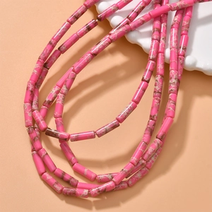 Close-up of cylindrical pink marble stone beads for DIY jewelry making and necklaces