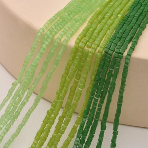 Macro view of 2mm green faceted crystal glass square beads for DIY jewelry making