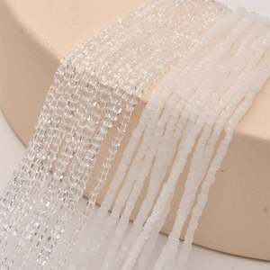 Macro shot of 2mm square glass crystal beads in transparent and frosted white finish