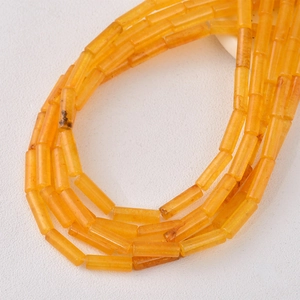 Macro detail of cylindrical amber resin tube beads with polished natural texture for DIY jewelry