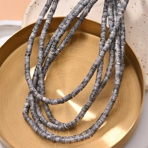 Close-up of multilayer cylinder stone beads with grey marble texture for jewelry DIY