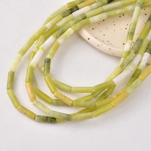 Macro shot of cylindrical natural stone beads in green and yellow for DIY jewelry