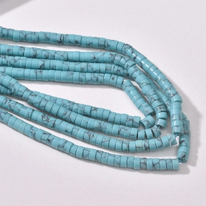 Detailed macro view of blue turquoise spacer beads with natural black matrix for DIY jewelry