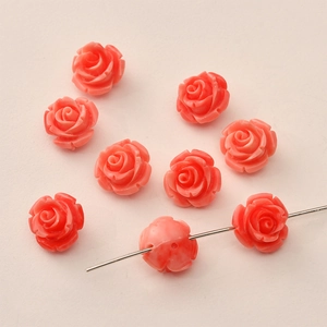 Macro view of 12mm coral pink resin rose flower beads for DIY jewelry with center hole