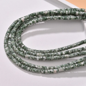 Macro shot of green and white natural stone cylinder beads for DIY jewelry making
