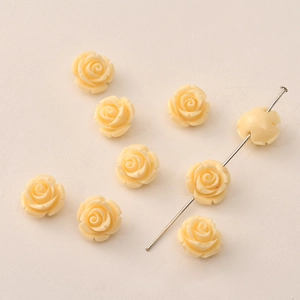 Macro detail of 12mm cream pink resin rose beads with center holes for DIY jewelry