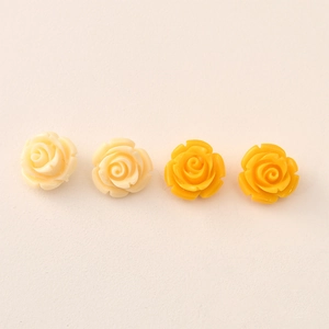 Detail showing four yellow gradient 12mm resin rose flower beads for DIY jewelry making