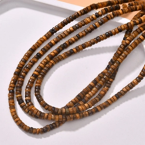 Macro view of brown tiger eye stone beads on a tray for DIY jewelry making