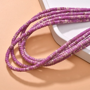 Macro view of purple spotted cylindrical stone beads for vintage DIY jewelry making
