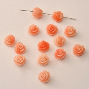 Macro view of 12mm salmon pink resin rose flower beads for DIY jewelry making