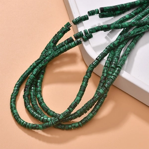 Macro detail of cylinder malachite-pattern synthetic beads for jewelry making projects
