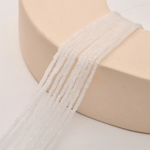 Macro detail of 2mm square white translucent crystal glass beads for DIY jewelry making
