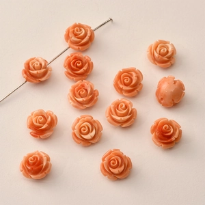Detailed view of 12mm coral rose flower beads for DIY jewelry making with through-holes