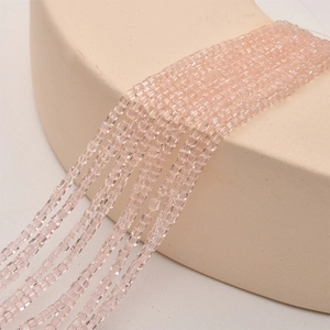 Macro detail of 2mm faceted peach crystal square beads for DIY jewelry making