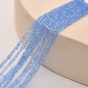 Macro shot of 2mm blue square crystal glass beads with light reflection for DIY jewelry