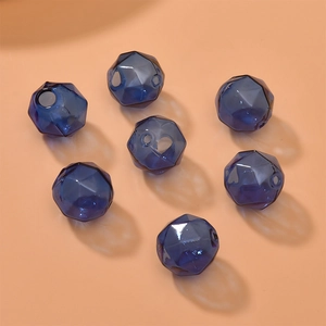 Macro view of blue faceted hollow glass beads with geometric cuts for DIY jewelry making