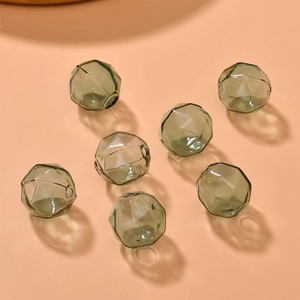 Macro detail of dark green faceted glass hollow beads with precision cut for DIY jewelry