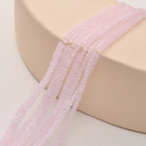 Macro view of 2mm square light purple crystal glass beads with faceted texture for DIY