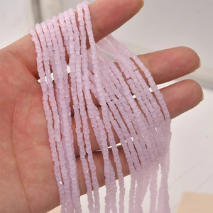 Close-up of 2mm faceted lavender crystal glass square beads for DIY jewelry making
