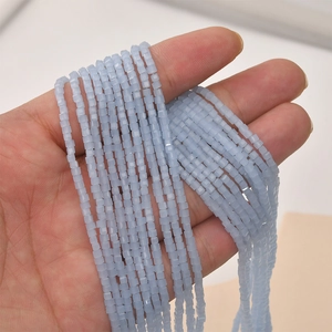 Macro shot of 2mm light blue cube crystal glass beads for DIY jewelry making and crafting