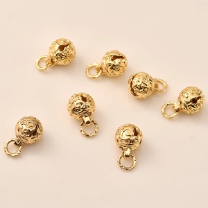Detail showing 14K gold plated hollow bell charms with celestial star engraving for jewelry