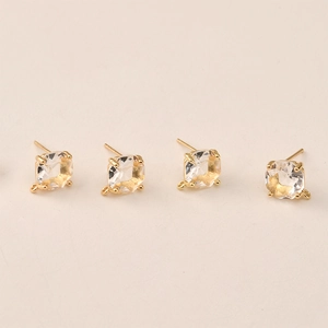 Macro shot of 14k gold-plated square rhinestone ear studs with DIY hanging loops
