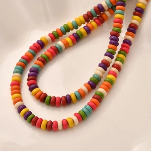 Close-up of colorful rondelle turquoise beads in a U-shape for DIY jewelry making