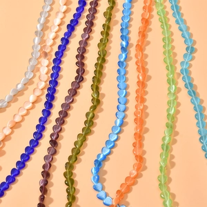 Macro shot of 8mm heart-shaped cat eye beads in vibrant colors for DIY jewelry making