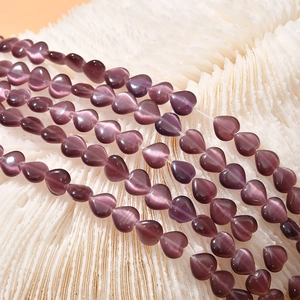 Macro shot of 8mm purple cat-eye stone beads in heart shape for DIY jewelry making