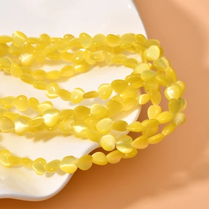 Macro shot of 8mm yellow heart cat eye stone beads for DIY jewelry making accessories