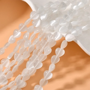 Macro view of 8mm heart-shaped cat eye stone beads with vertical holes for DIY jewelry