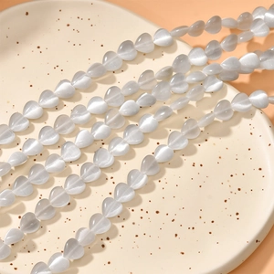 Detailed view of 8mm heart-shaped cat eye stone beads for DIY jewelry making