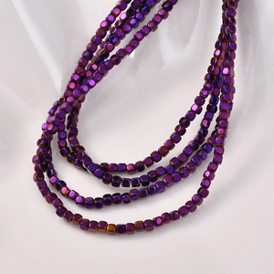 Close-up of 3mm square hematite beads with iridescent purple metallic luster for jewelry DIY