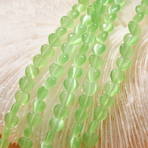 Macro view of 8mm green heart cat eye stone beads for vintage DIY jewelry making
