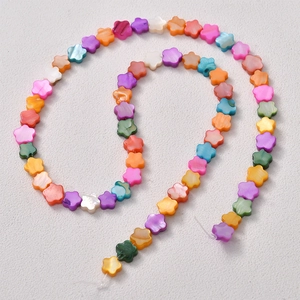Macro detail of colorful floral shell beads with pearlescent finish for jewelry DIY